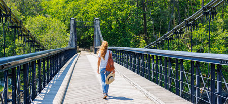 traveler woman on suspended bridge- adventure, wanderlust concept