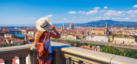 Happy woman with arms raised up enjoying panoramic of Florence Cityscape- tour tourism,travel,vacation in Italy-Europe, Firenzeの写真素材