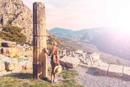 Ancient city of Delfi, ruins of temple of Apollo, Theater and female tourist- Travel, tour tourism...
