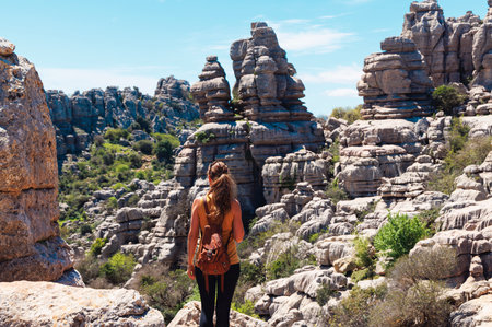 Rear view of tourist woman with bag enjoying landscape natural geological rock (torcal)Andalusia in Spainの写真素材