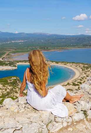 Woman tourist enjoying view of Voidokilia beach, Pylos, Peloponnese in Greece- Travel, tour tourism,...
