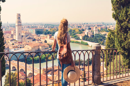 Rear view of woman holding Italian flag in Verna city- Travel destination, tour tourism in Italy, Europeの写真素材