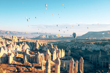Hot air balloons flying above GÃ¶reme, Cappadocia - Anatolia, Turkey at sunriseの写真素材