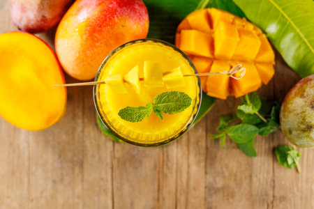 Top View of Mango Smoothie or Juice with Fresh Fruits â Healthy and Refreshing on Wooden Backgroundの写真素材