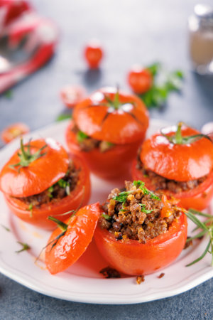 stuffed tomato with ground meat and herbsの写真素材