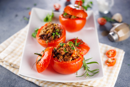 stuffed tomato with ground meat and herbsの写真素材