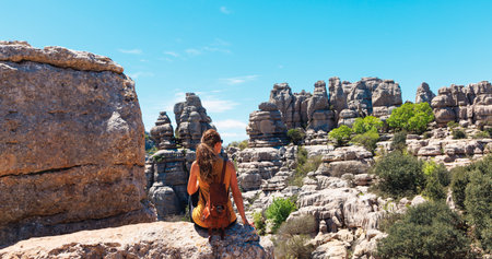 Woman sitting on rock enjoying panoramic of Torcal, Andalusia, Malaga province in Spain