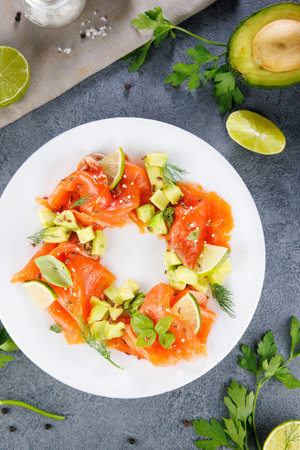 smoked salmon fillet and avocado on plateの写真素材