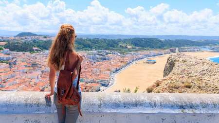 Young Woman Admiring One of Portugal's Most Beautiful Beachesの写真素材