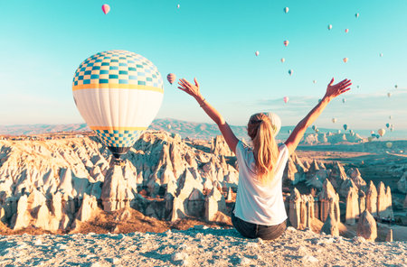 Happy Woman Enjoying a Hot Air Balloon Ride in Cappadociaの写真素材