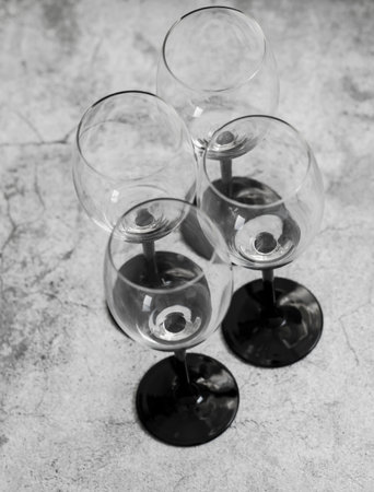 Wine glasses. They stand or lie on a gray background. They are filled with wine and coffee, cranberries.の写真素材