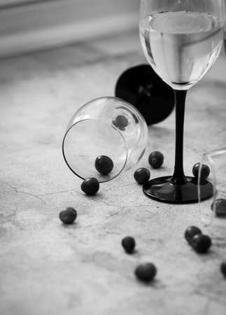 Wine glasses. They stand or lie on a gray background. They are filled with wine and coffee, cranberries.の写真素材
