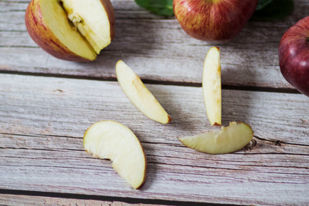 Big red apples lie on a wooden tableの写真素材
