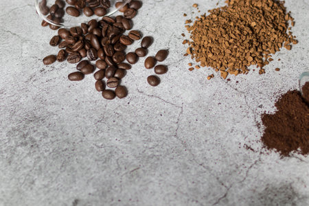 Instant coffee, coffee beans and ground coffee. All this on a gray backgroundの写真素材