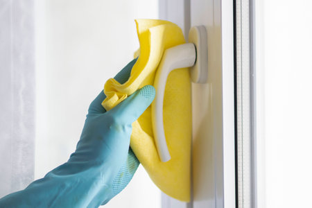 Cleaning. Washing the window and table with a napkin and gloves.の写真素材