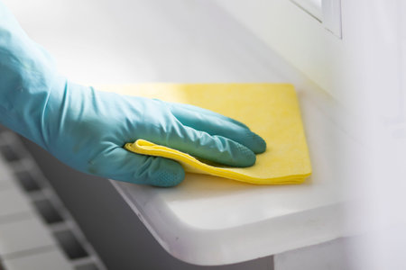 Cleaning. Washing the window and table with a napkin and gloves.の写真素材