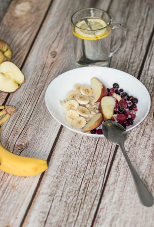 Oatmeal with berries and banana, apples.の写真素材