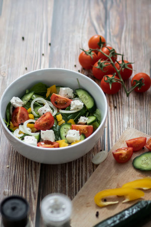 Green vegan salad made from a mixture of green leaves and vegetables.の写真素材