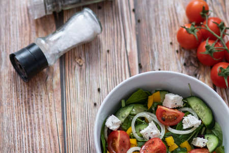 Green vegan salad made from a mixture of green leaves and vegetables.の写真素材