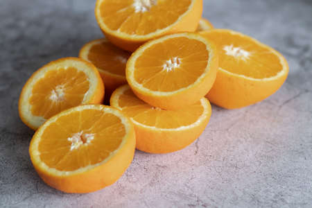 The orange halves are on the table. On a gray and white background.の写真素材