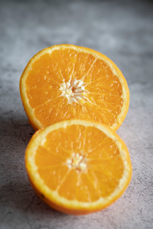 The orange halves are on the table. On a gray and white background.の写真素材