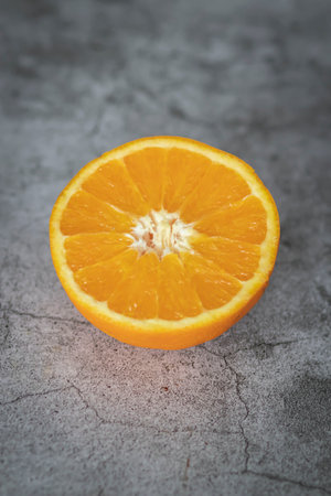 The orange halves are on the table. On a gray and white background.の写真素材
