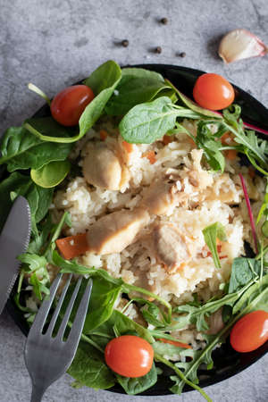 Rice pilaf with meat and vegetables. On a gray backgroundの写真素材