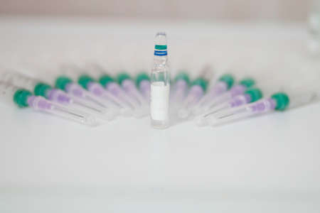 Medications. Ampoule of a medical syringe isolated on a white background. Pills.
