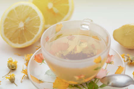 Green tea in a beautiful cup, with lemon and ginger