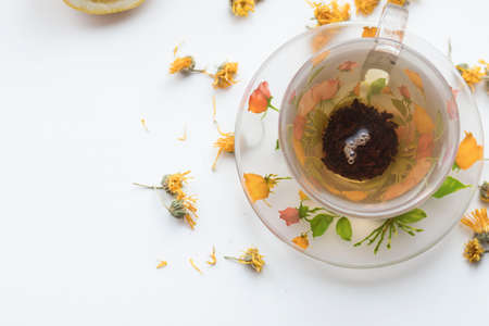Green tea in a beautiful cup, with lemon and gingerの写真素材