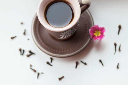There is a beautiful coffee cup by the window. And there are books nearbyの写真素材
