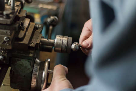 metalworking industry: working on a lathe with flying sparks. Latheの写真素材