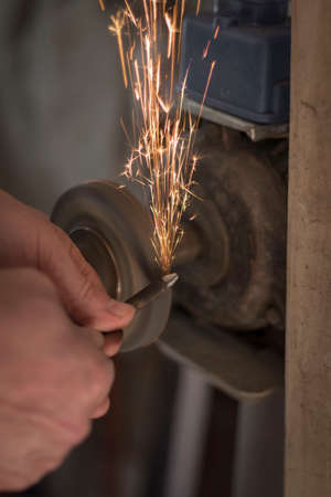metalworking industry: working on a lathe with flying sparks. Latheの写真素材