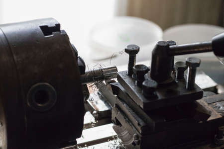 metalworking industry: working on a lathe with flying sparks. Latheの写真素材