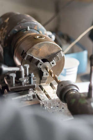 metalworking industry: working on a lathe with flying sparks. Latheの写真素材