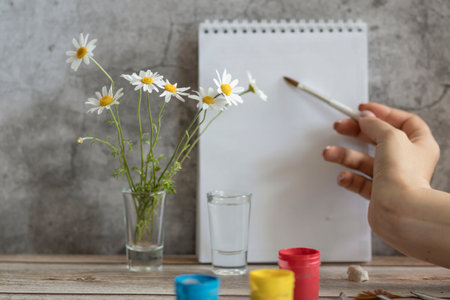 Drawing with paints for the artist. Standing on the table, next to brushes and paintsの写真素材