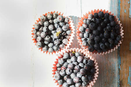 Blueberries on the table. Berries in bowls and in a jar.