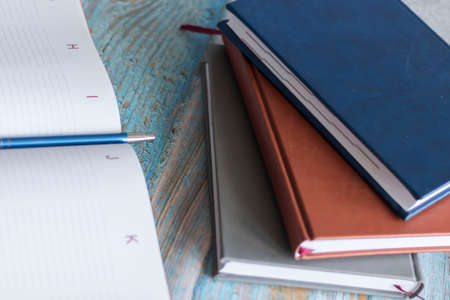 Workplace with notebooks and pen. Lie on the table.