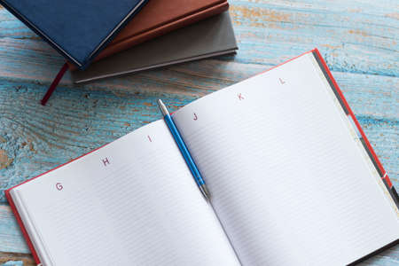 Workplace with notebooks and pen. Lie on the table.