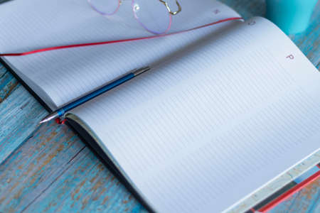 Workplace with notebooks and pen. Lie on the table.