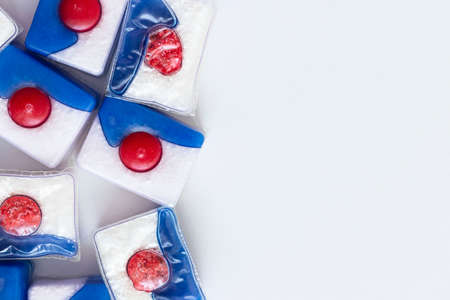 Dishwasher tablets, on white background with utensils