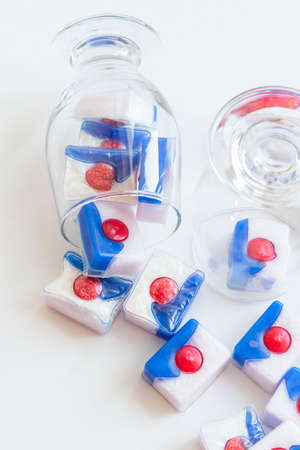 Dishwasher tablets, on white background with utensilsの写真素材