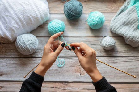 Knitting with needles. Against the background of a tree. handmadeの写真素材