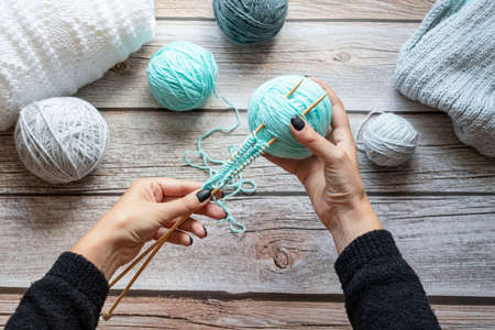 Knitting with needles. Against the background of a tree. handmade