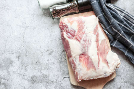 Piece of raw pork on a gray background. Fresh meat is ready to cook. view from aboveの写真素材