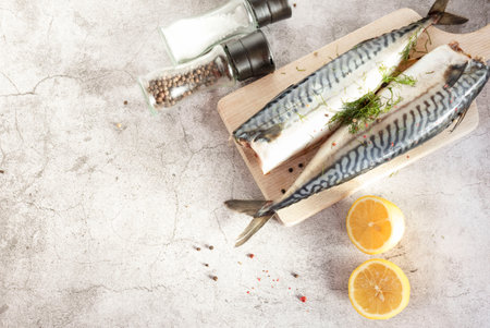 Fresh raw mackerel fish. On a gray background. Raw fish with lemon and dressingsの写真素材
