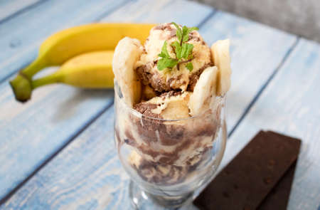 Chocolate banana ice cream. On gray and tree background