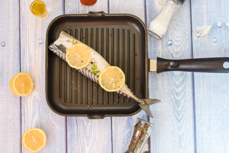 Raw mackerel fish. Cooking fish in a pan.の写真素材
