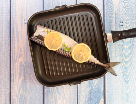 Raw mackerel fish. Cooking fish in a pan.の写真素材