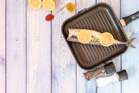 Raw mackerel fish. Cooking fish in a pan.の写真素材